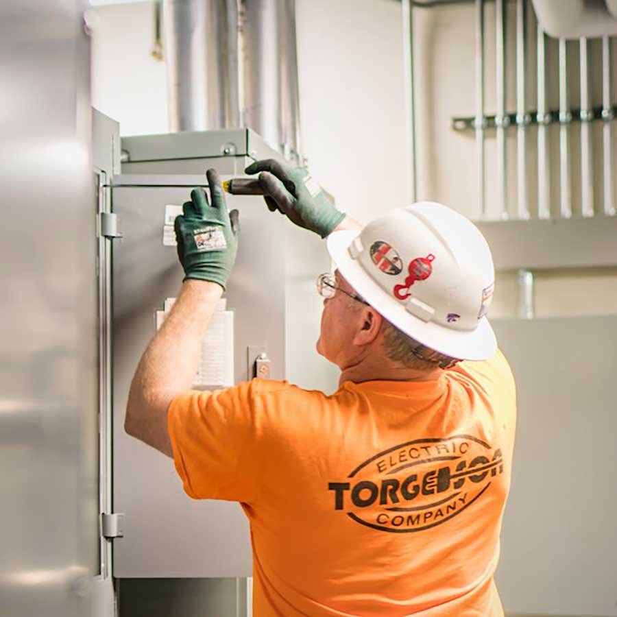 Industrial Torgerso Electric employee working on project testing